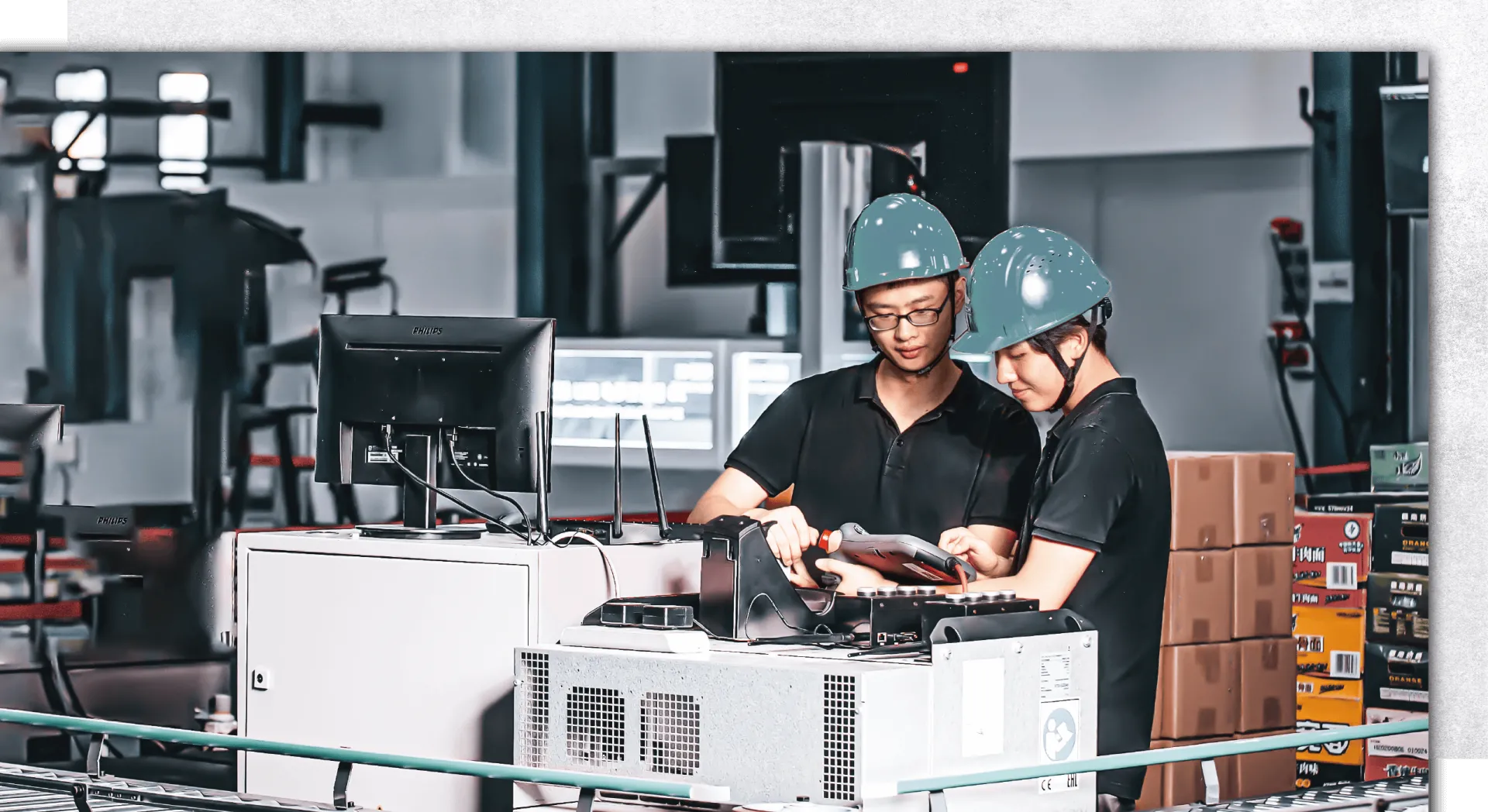 About Factory Two Skadi engineers wearing safety helmets working together on a refrigeration unit in a high-tech manufacturing facility, highlighting the company's emphasis on innovation, technical expertise, and quality control.